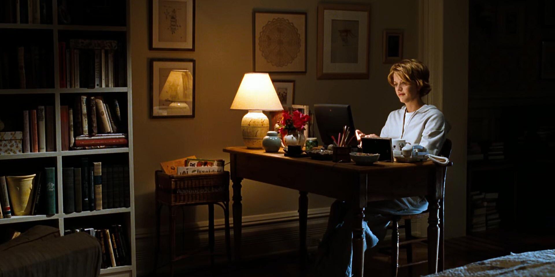 A still from the 1998 film "You've Got Mail": A casually dressed woman sits in her study working on her laptop.